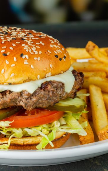 a classic cheeseburger with shredded lettuce and a blend of cheeses