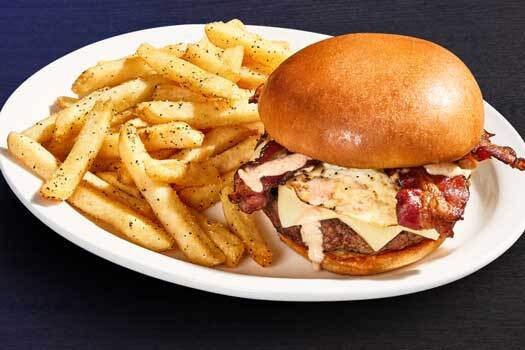 a brunch burger from millers ale house with a side of fries